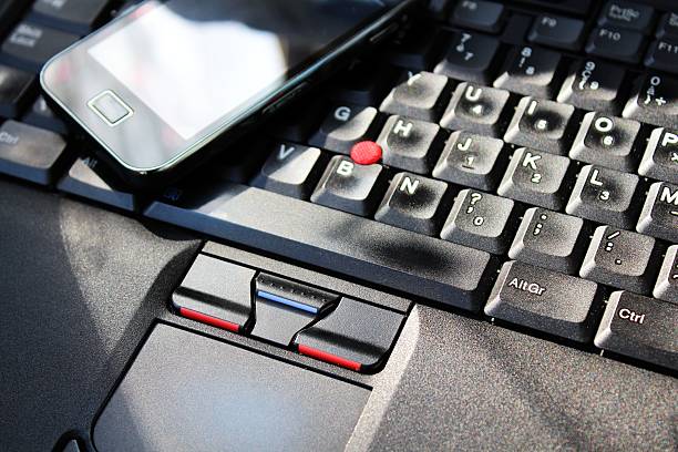 istock Smart phone on the keyboard of laptop 455279905