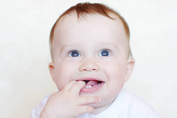istock nice baby with fingers in mouth 455279927