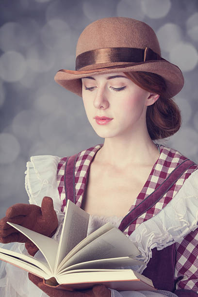 istock Beautiful redhead women with book. 455280815
