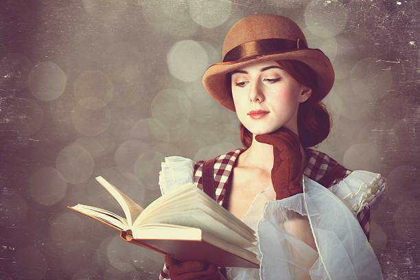 istock Beautiful redhead women with book. 455280861
