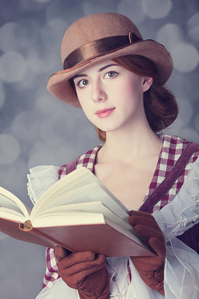 istock Beautiful redhead women with book. 455281013