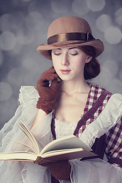 istock Beautiful redhead women with book. 455281051