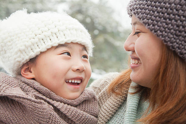 istock Mother and daughter looking at each other in winter 455290185