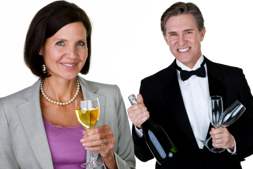 Mature man and woman celebrating with champagne 