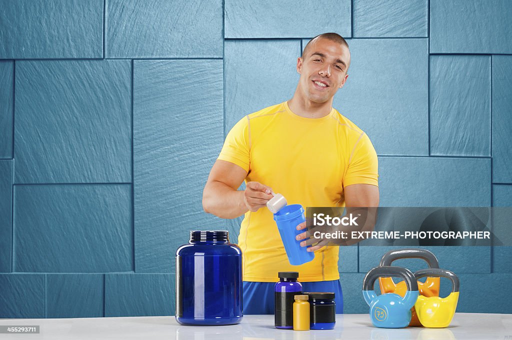Male bodybuilder with supplement stack Young male athlete preparing protein shake. Active Lifestyle Stock Photo