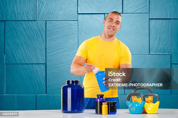 Male Bodybuilder With Supplement Stack Stock Photo - Download Image Now - Active Lifestyle, Activity, Anaerobic Exercise