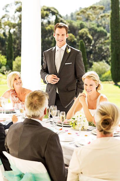 istock Groom And Bride With Family At Reception 455294275