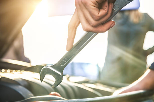 Auto mechanic fixing a car engine Auto mechanic fixing a car engine. wrench photos stock pictures, royalty-free photos & images