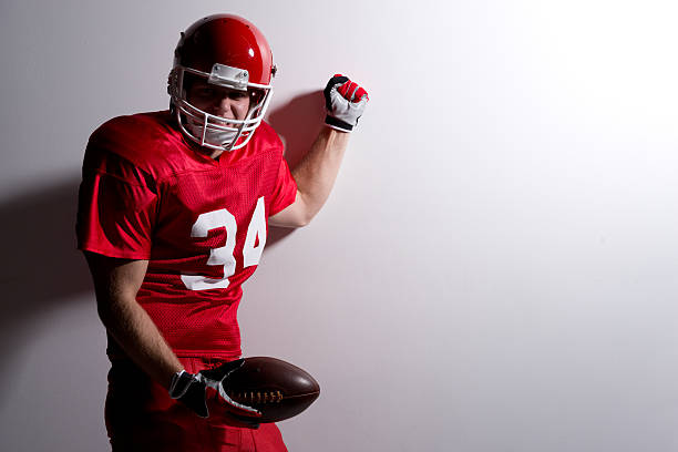 istock American football player with ball 455295397