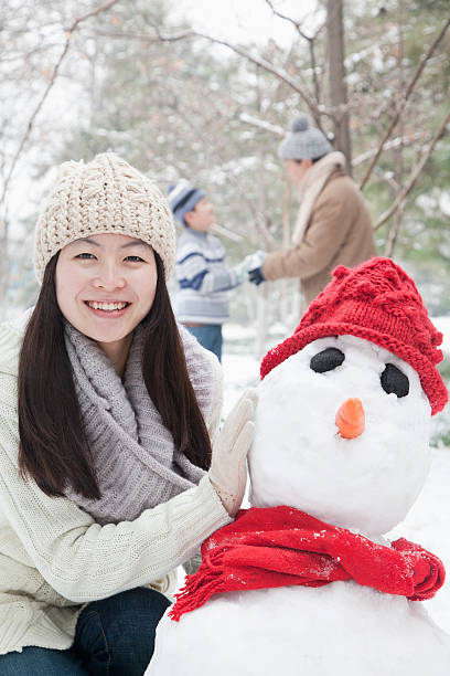 istock Mother making snowman in winter 455297611