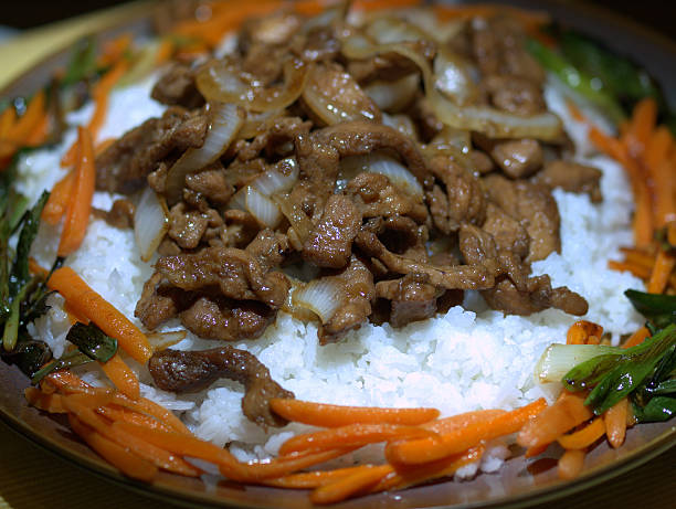 istock sliced pork meal on bed of rice 455301433