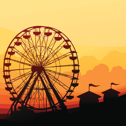 Amusement park with ferris wheel background with copy space.