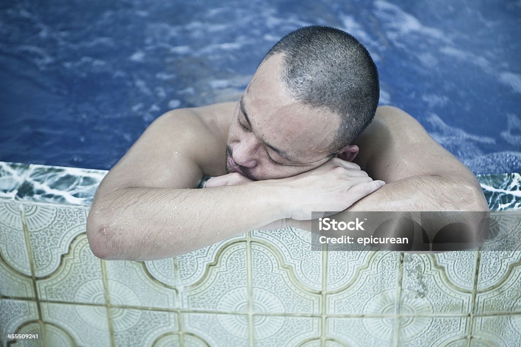 Japanese man relaxing in traditional Onsen bath A Japanese man relaxes at the end of the day in one of the many traditional "Onsen" (or public baths) that are a part of everyday life in Tokyo, Japan. Sauna Stock Photo