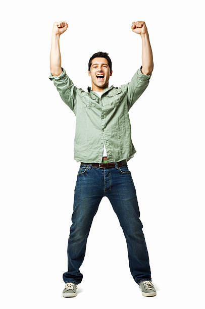 Handsome Young Man Cheering - Isolated Handsome young man cheers with arms raised into the air. Vertical shot. Isolated on white. arms raised stock pictures, royalty-free photos & images