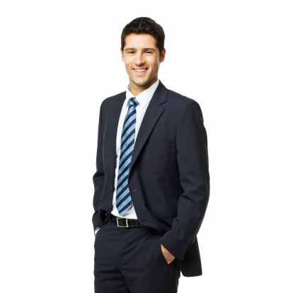 Young businessman standing confidently with his arms crossed. Vertical shot. Isolated on white.