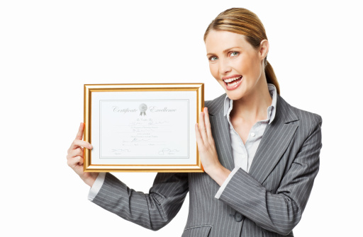 Attractive businesswoman holds up a framed certificate of excellence. Horizontal shot. Isolated on white.