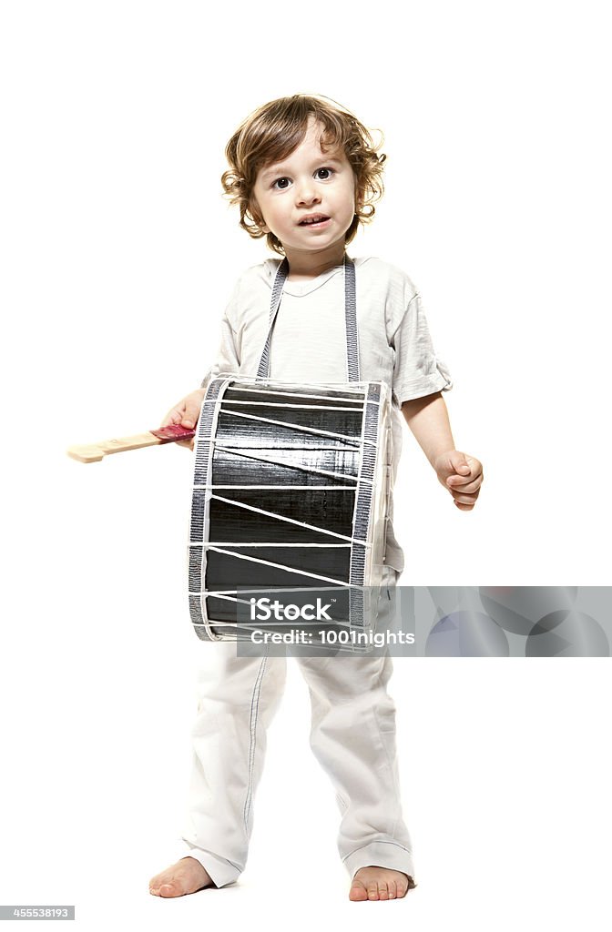 Adorable little boy An adorable little boy playing with a drum, against a white background. Child Stock Photo