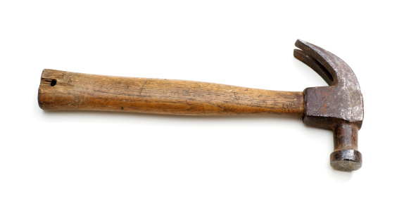 Vintage claw hammer with wooden handle against white background