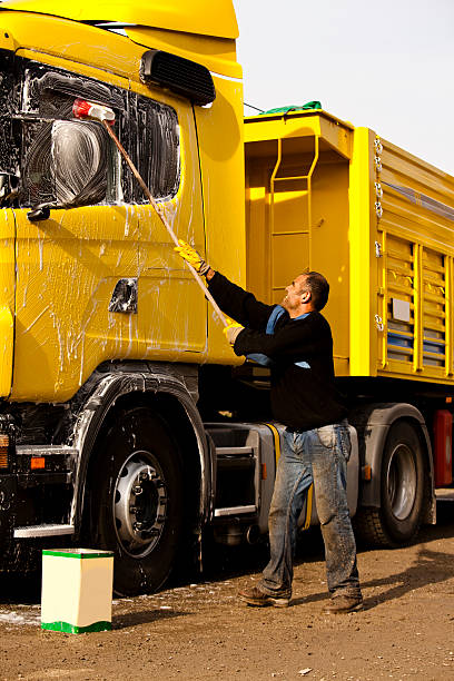 Mature man washing his truck stock photo