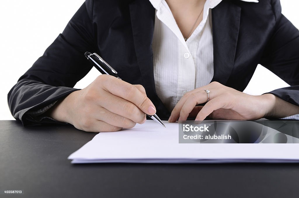 Filling in a form Business woman filling form at the table. Adult Stock Photo