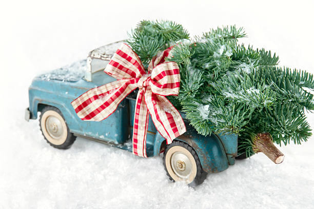 istock Blue toy truck carrying a Christmas tree 455603321