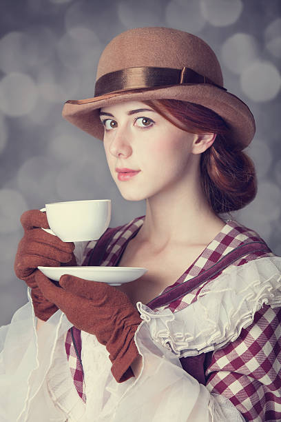 istock Beautiful redhead women with cup of tea. 455605015