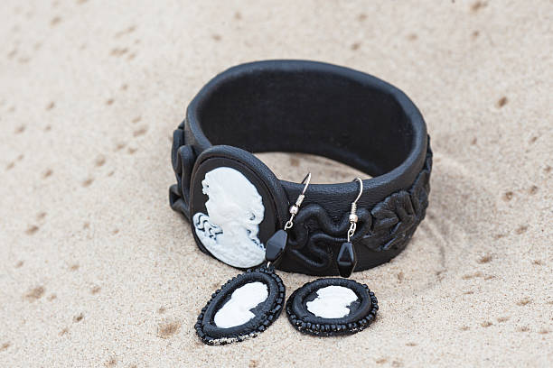 istock Handmade bracelet with leather on sand 455607059