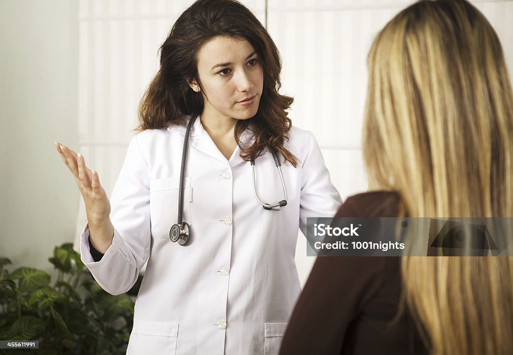 Doctor and patient Doctor talking to her patient Adult Stock Photo