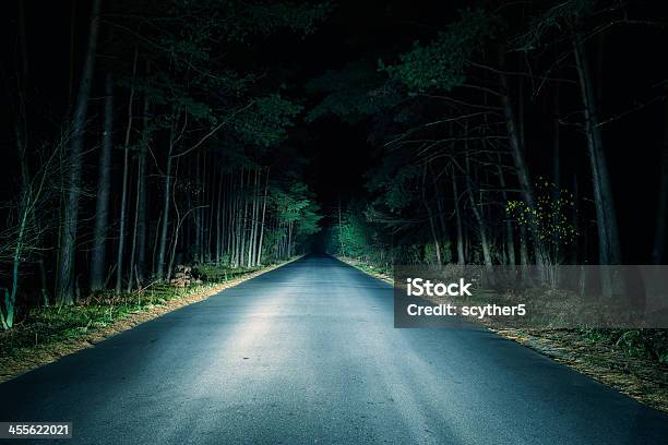 Paved Road Going Through Woods At Night Stock Photo - Download Image Now - Night, Road, Dark