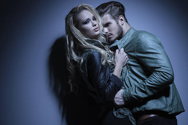 istock woman in leather jacket is pulling her lover closer 455624755