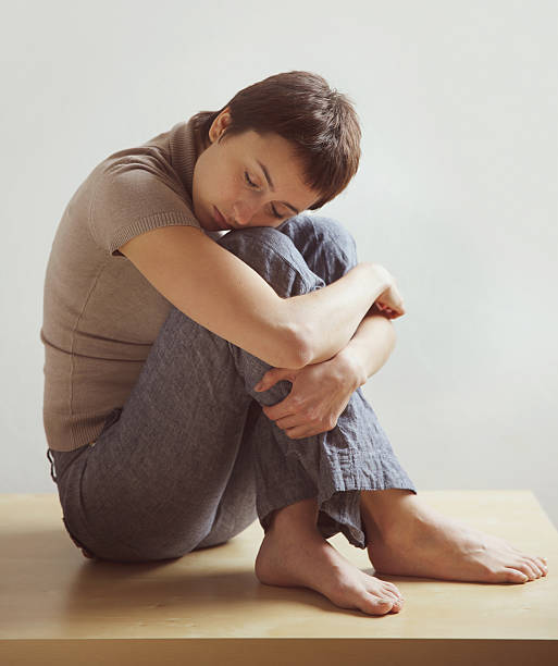 istock Beautiful woman sitting, hugging his knees 455626179