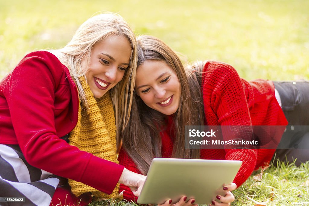 Happy friends using digital tablet Adult Stock Photo