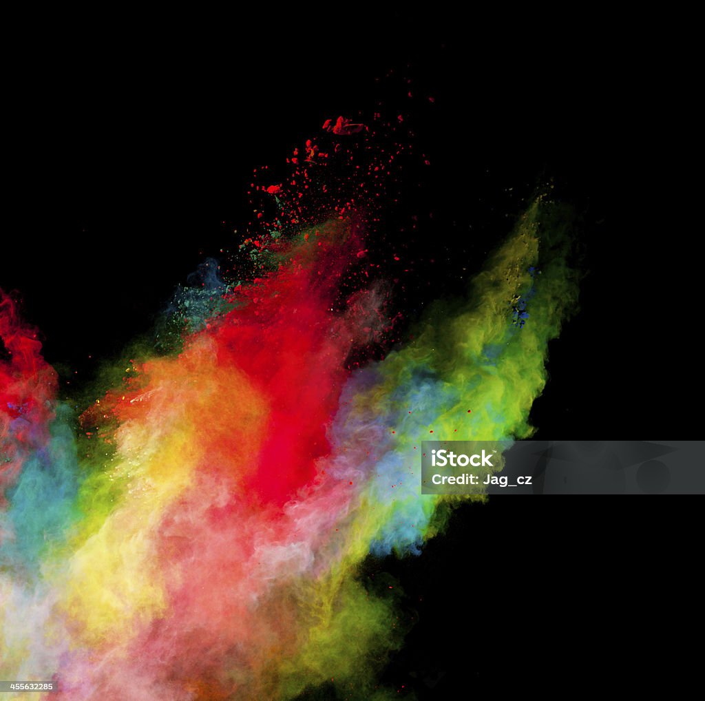 colored dust Freeze motion of colored dust explosion isolated on black background Abstract Stock Photo