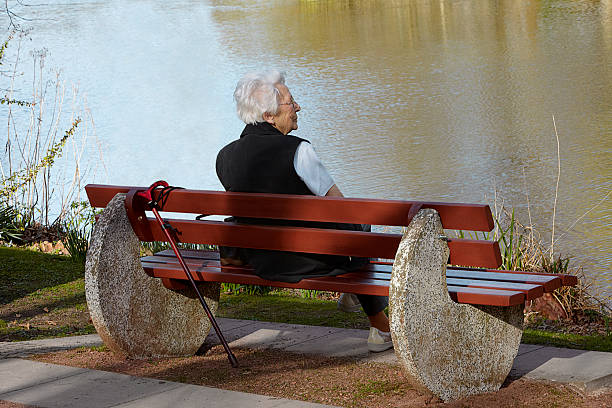istock Old woman sitting on a bench 455637715