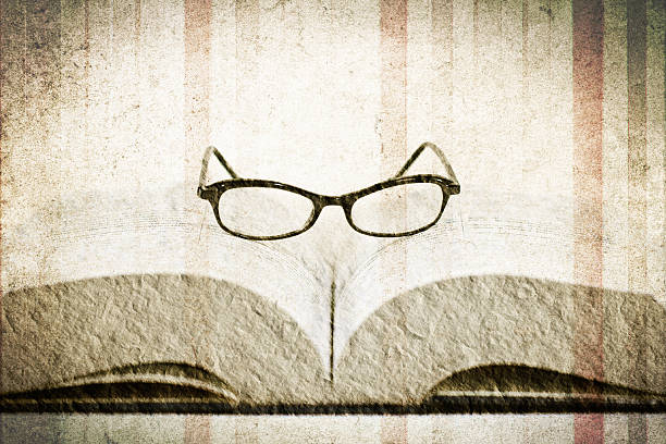 reading glasses on the book stock photo