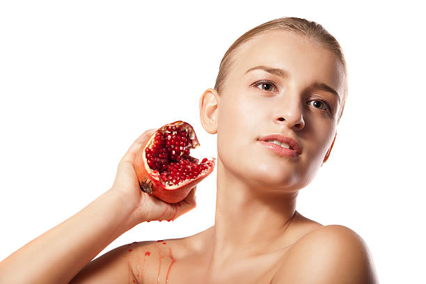istock Beautiful woman with pomegranates in her hands 455642647