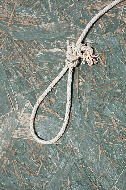 istock Rope noose over wooden background 455655277