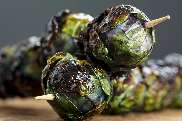 Grilled Purple Brussel Sprout Kabobs on Skewers stock photo