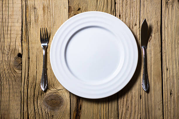 istock Fish cutlery and plate on rustic wooden table 455660231