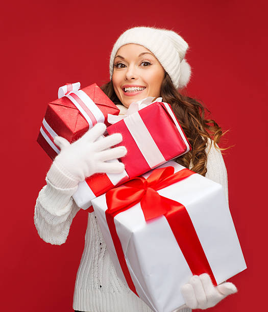 istock woman in sweater and hat with many gift boxes 455662975