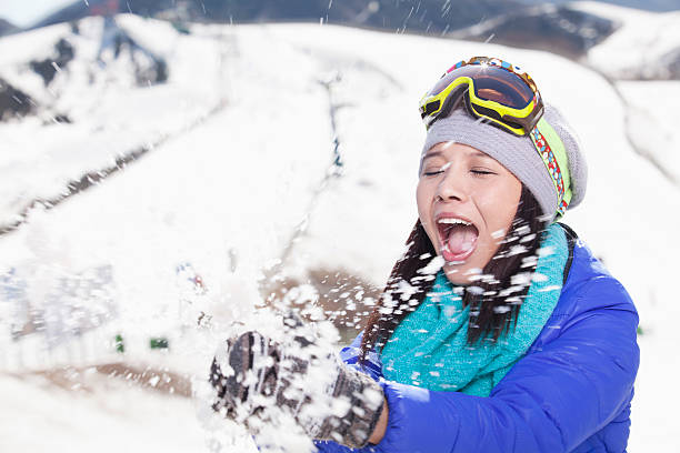 istock Young Woman Playing With Snow 455668843