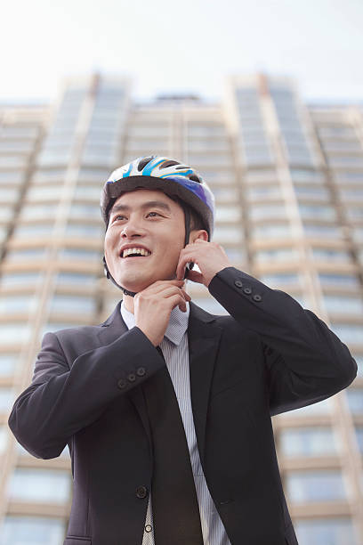 istock Businessman putting on cycling helmet 455669119