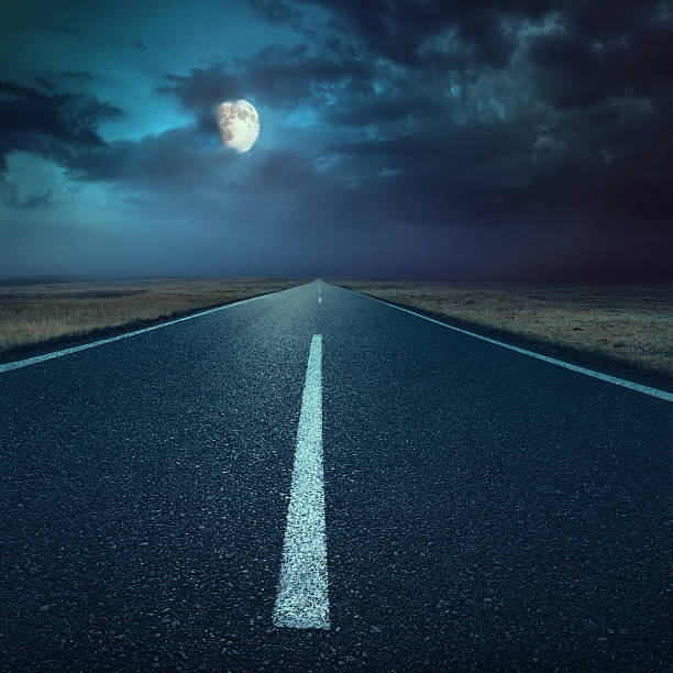 istock Driving on asphalt road at night towards the moon 455669267