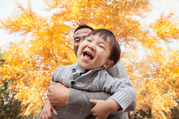 istock Father and Son Playing a Park in Autumn 455669699