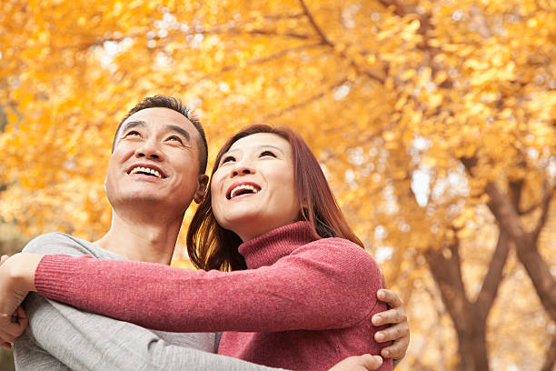 istock Mature Couple Embracing in Park 455669829