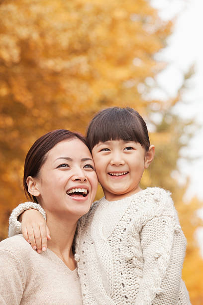 istock Mother and Daughter Enjoying a Park in Autumn 455669949