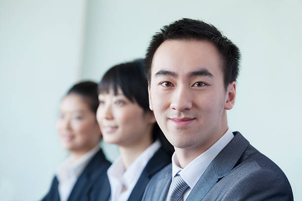 istock Three Business People in a row smiling 455670355