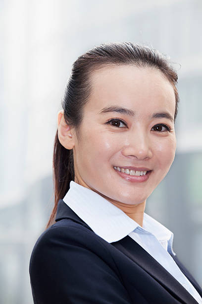 istock Young Businesswoman Smiling and Looking At Camera Urban Setting 455670497