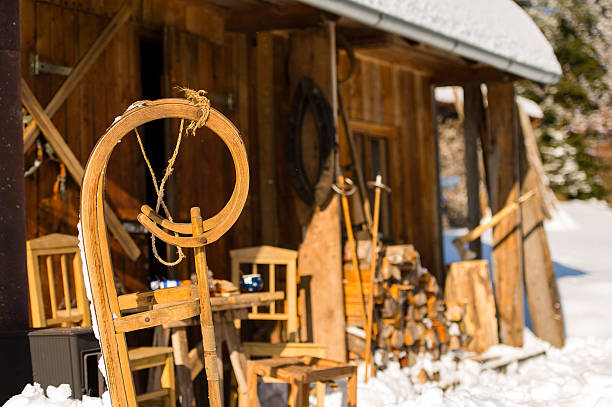 istock Winter snow cottage wooden sledge outside 455672767