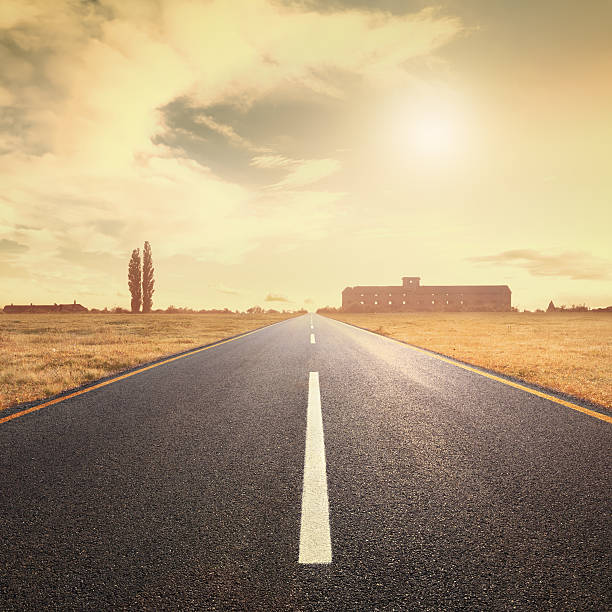 istock Driving on asphalt road at sunset towards the sun 455683463